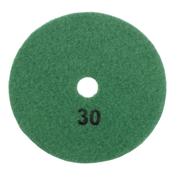 A circular green polishing pad with a central hole, used for diamond polishing of stone and concrete.
