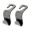 A pair of black and clear rhinestone car headrest hooks for storing bags and clothes.