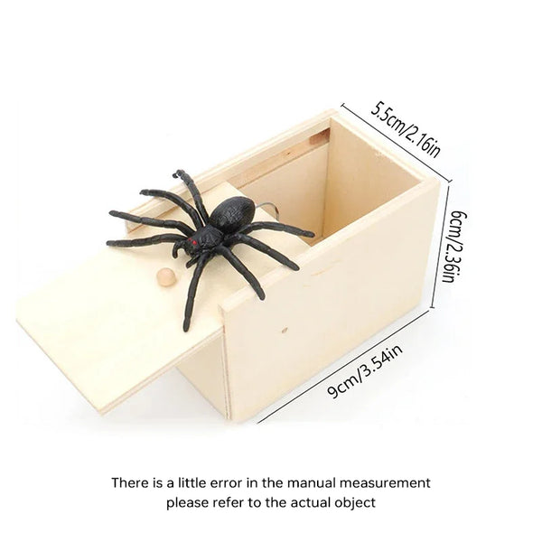 A wooden box containing a black spider, used as a surprise or prank item.