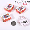 A box of mini playing cards with a red and yellow design and a coin shown next to them.