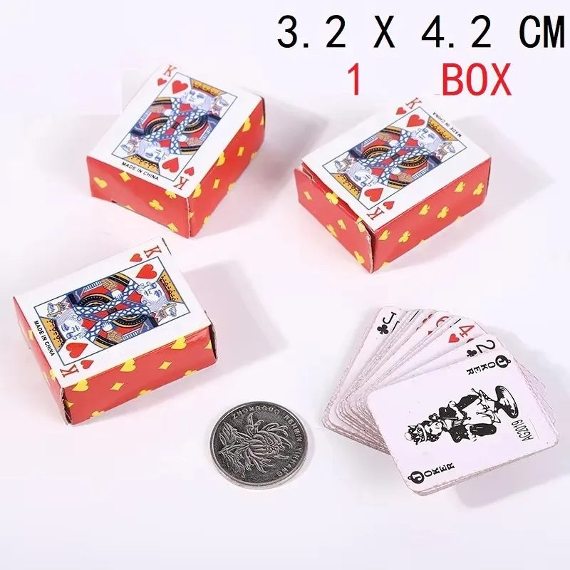 A box of mini playing cards with a red and yellow design and a coin shown next to them.