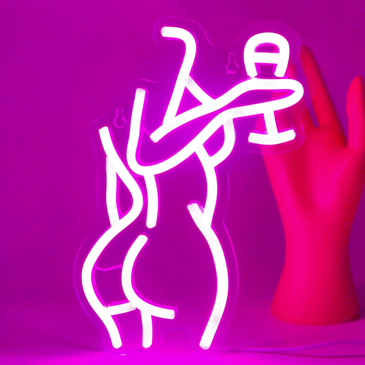 A bright pink neon silhouette of a female figure is displayed against a magenta background.