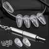 A set of clear silicone nose pads and a mini screwdriver for glasses repair displayed on a dark surface.