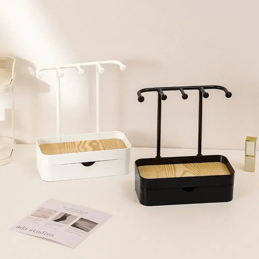 Elegant jewelry display rack with a drawer and wooden base featuring black and white components.