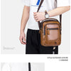 A brown leather crossbody shoulder bag worn by a man, displayed against a white background.