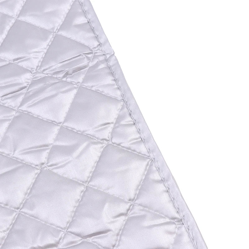 A close-up view of a white quilted ironing mat fabric.