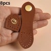 Eight brown leather buckle clasps with gold accents held in a person's hand.