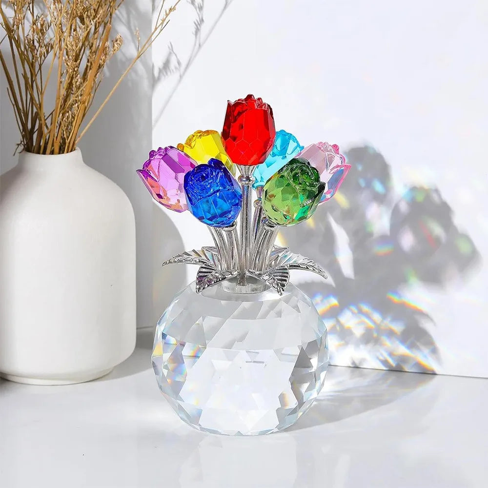 A crystal rose sculpture with a bouquet of colorful, reflective glass flowers displayed in a clear glass vase.
