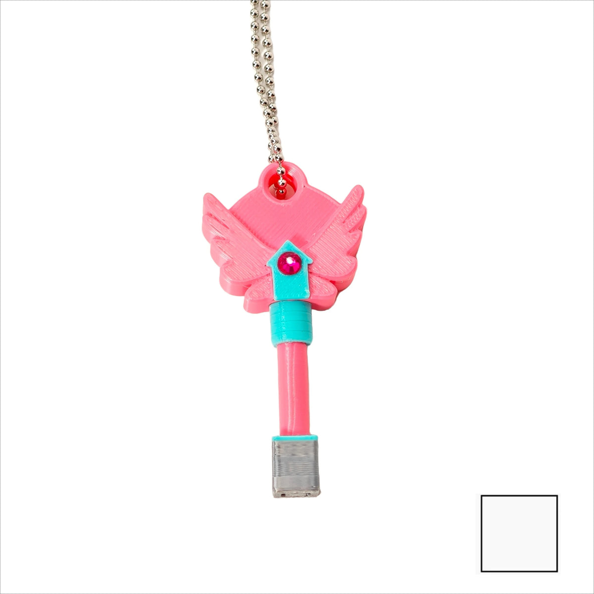 A pink dagger key necklace with a silver charm hanging from a chain.