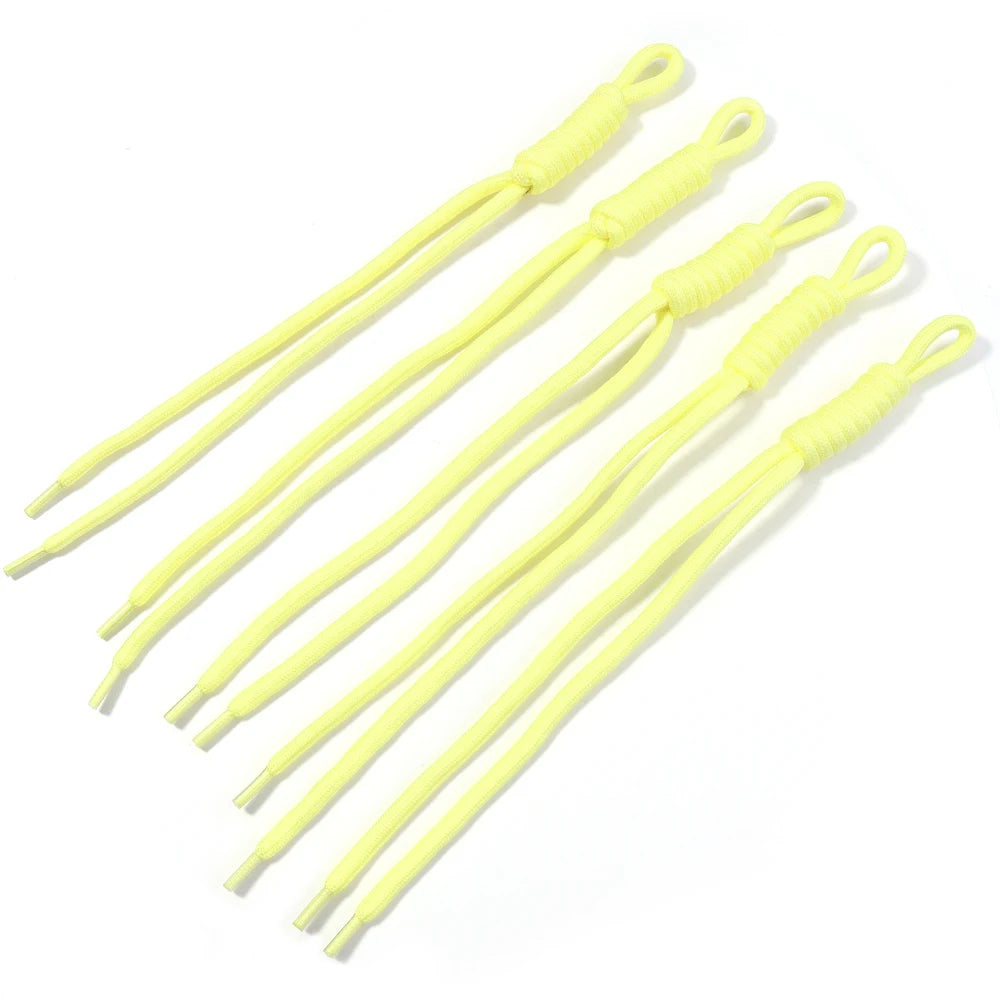 A collection of bright yellow braided nylon lanyards or keychains.