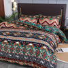 Boho striped geometric duvet cover set featuring intricate patterns in teal, orange, and navy on a dark brown bed.