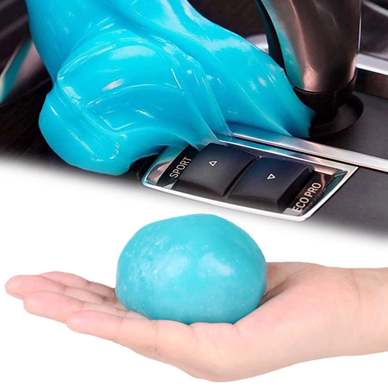A hand holds a bright blue reusable cleaning gel, next to a car detailing tool.