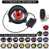 A black LED headlight lens with a red iris, connected by a wire to a remote control and various emoicons and car logos.