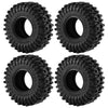 A set of four black mud terrain rubber tires for RC crawlers, showing the tread pattern and mounting holes.