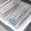 Clear jewelry organizer box with multiple secure compartments arranged in rows