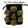 A set of seven yellow and black polyhedral dice packaged in a black pouch.