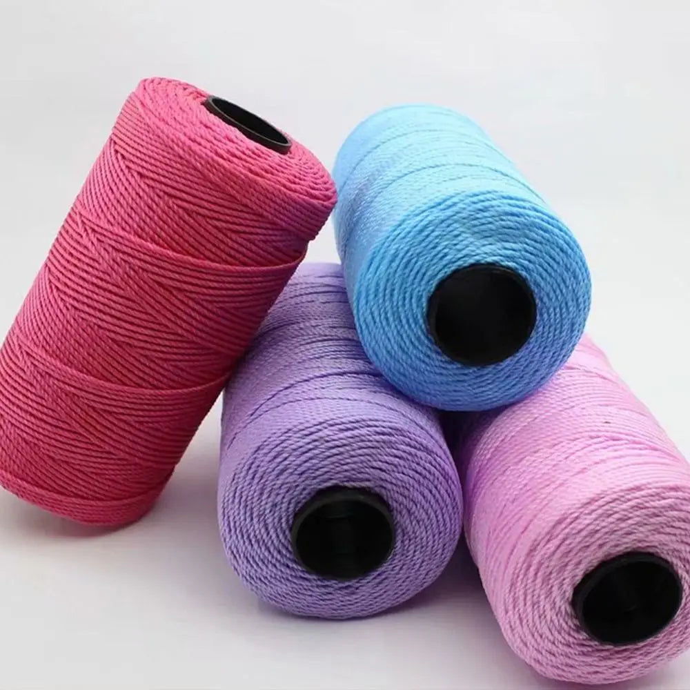 Three spools of pink, blue, and purple ice cotton silk thread for knitting and crochet