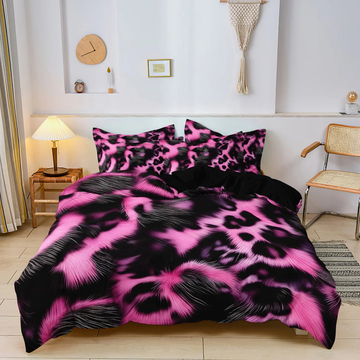 A black and pink leopard print duvet cover set displayed on a bed in a bright room.