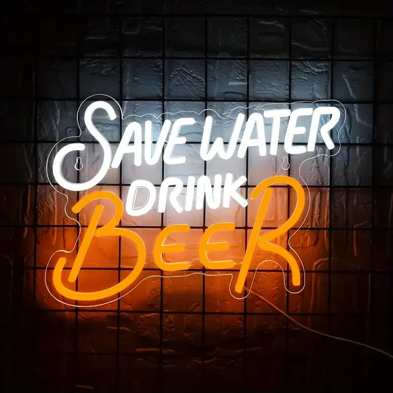 An orange neon sign glows on a dark brick wall with the text SAVE WATER DRINK BEER.
