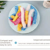 A collection of colorful disposable transparent waterproof shower caps arranged on a light plate.