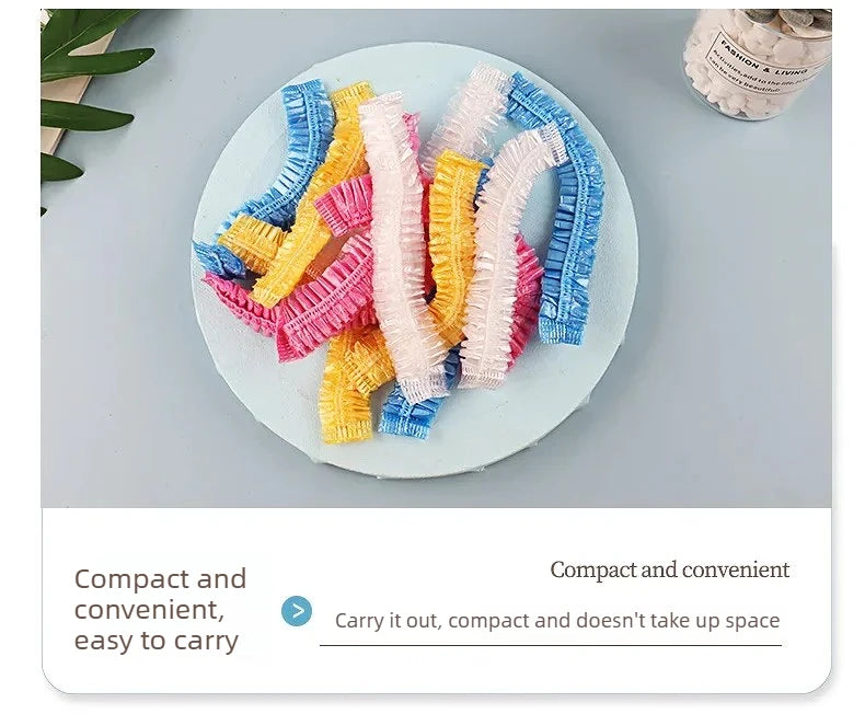 A collection of colorful disposable transparent waterproof shower caps arranged on a light plate.