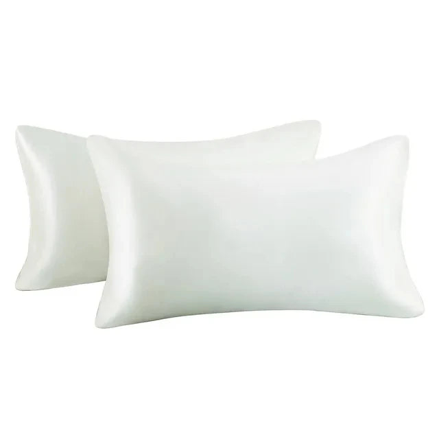 A set of two white silky satin pillowcases for hair and skin.