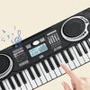 A hand plays a black 37-key electronic piano with an LED display and microphone, showing the keys and soundboard.