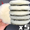A set of five white and black wool polishing pads for car detailing.