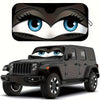 A black Jeep Wrangler is shown with a cartoon owl face sunshade installed on the windshield.