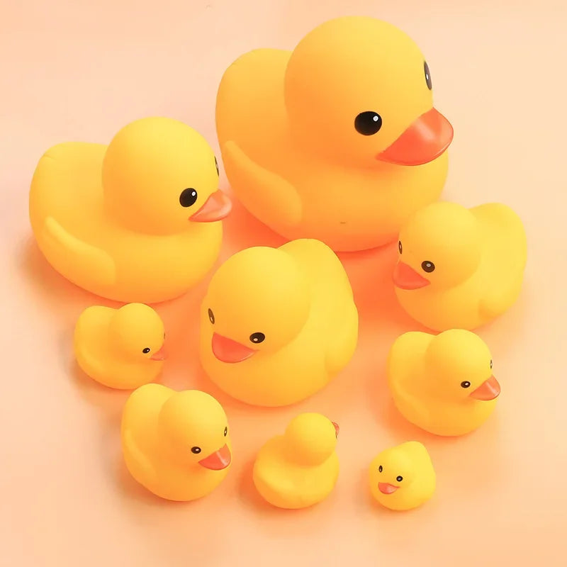 A collection of small, bright yellow duck toys for babies.