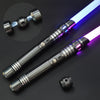 A sleek metal lightsaber with a glowing purple and blue blade is shown against a dark background.
