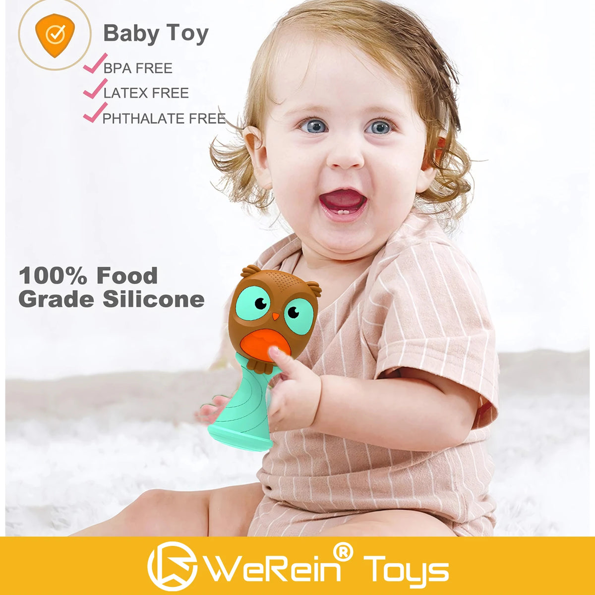 A baby is holding an owl-themed silicone rattle toy for sensory development.