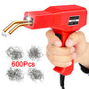 A hand holds a red plastic welding gun with a gold tip, next to several packs of metal wire.