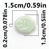 A small, pale green ceramic fish bead shown with dimensional measurements.