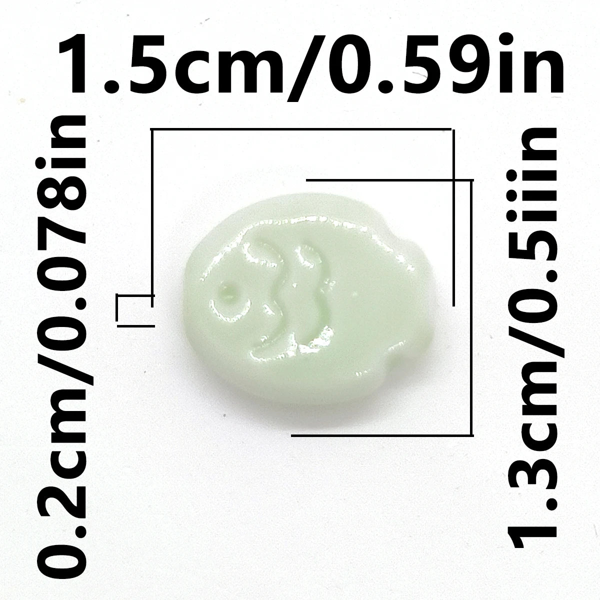 A small, pale green ceramic fish bead shown with dimensional measurements.