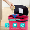 A hand opens a red automatic touchless trash can, demonstrating silent and inductive opening technology.