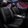 Black leather car seat covers with headrests and seat cushions shown inside a vehicle cabin.