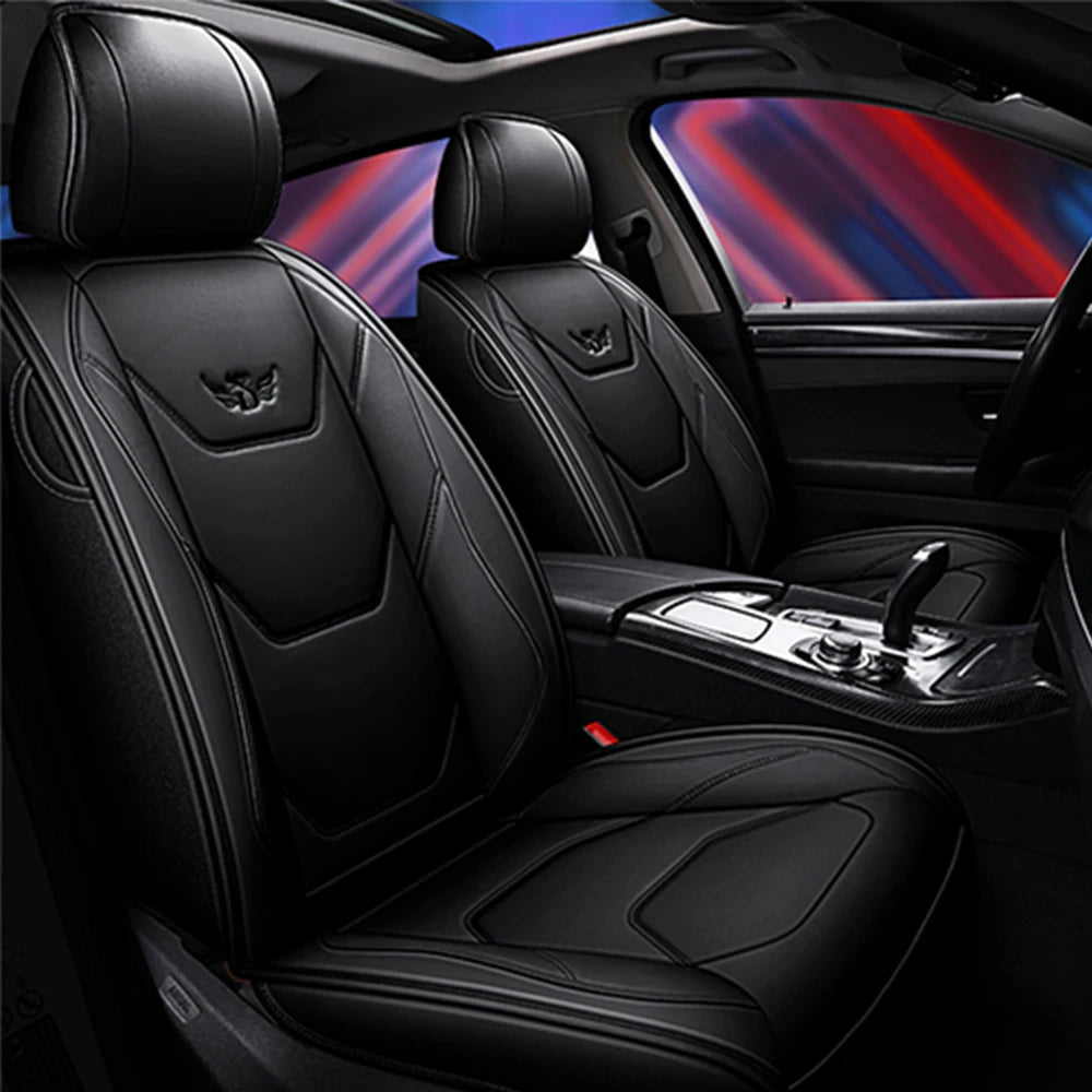 Black leather car seat covers with headrests and seat cushions shown inside a vehicle cabin.