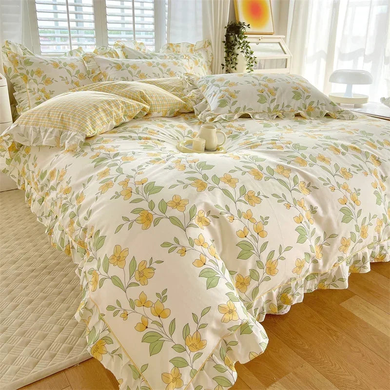 A floral ruffle cotton duvet cover set in pale yellow and green tones displayed on a bed.