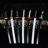 A set of five Demon Slayer mini katana replicas with various colored hilts and blades displayed on a dark background.