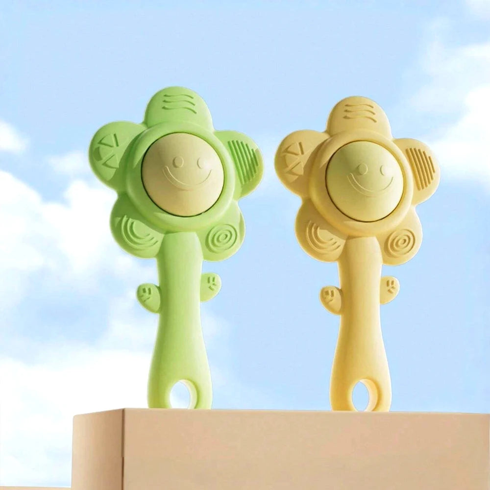 A pair of light green and yellow silicone baby teething rattles with a chewable gripper and shaker feature.