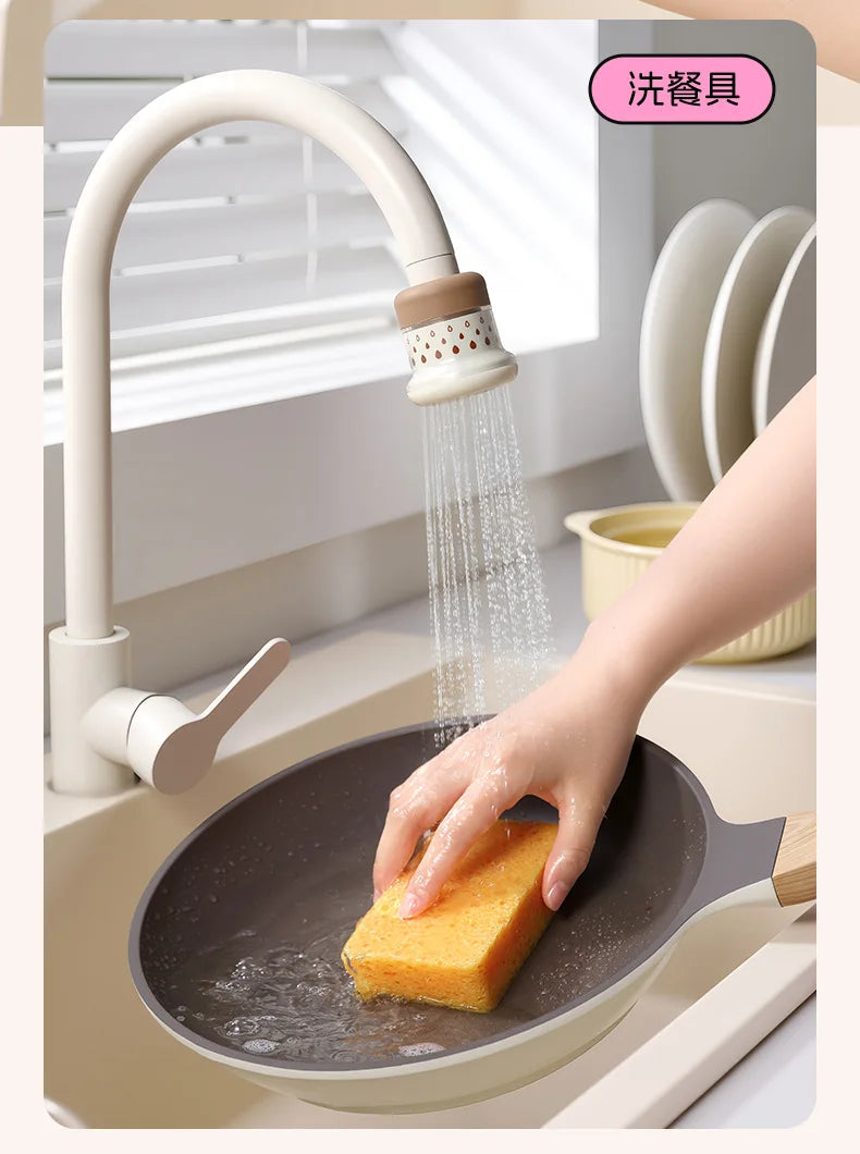 A hand is using a kitchen faucet sprayer to rinse food in a frying pan.