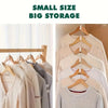 A display of small size big storage clothing items hanging on wooden hangers.
