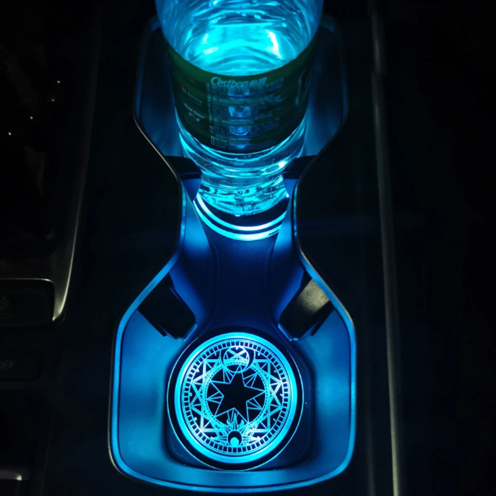 Close-up of a blue LED cup holder light illuminating a glass in a car interior.