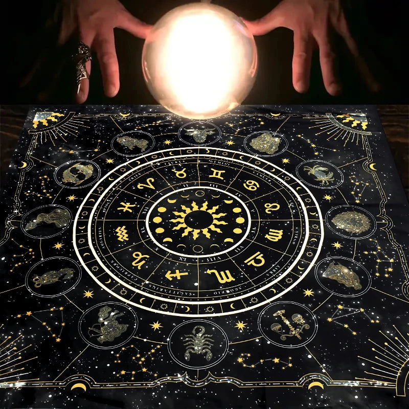 Hands holding a glowing orb above a mystical zodiac tarot tablecloth for readings and altars