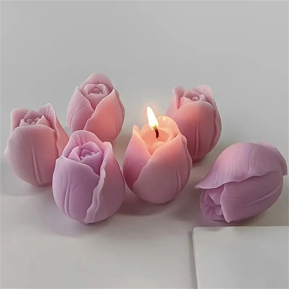 Pink silicone tulip molds shaped like roses used for making candles and soap