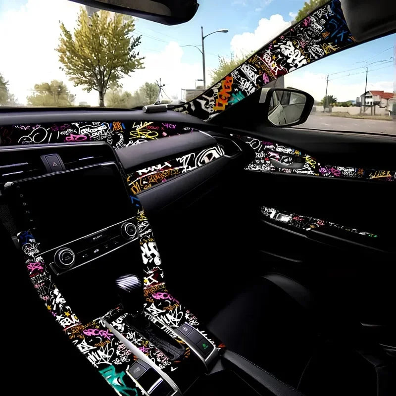 A close-up view of a car interior with a graffiti pattern velvet wrap sticker on the door and dashboard.