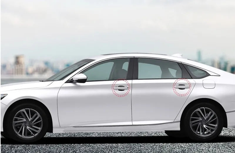 Side view of a white sedan showing door handle protector film on the doors.