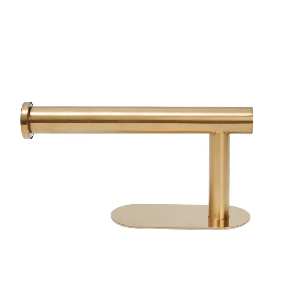 A brass stainless steel self-adhesive toilet paper holder with a horizontal bar and a flat base.