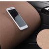 A silver smartphone rests on a brown car seat cushion, highlighting the product's non-slip texture.